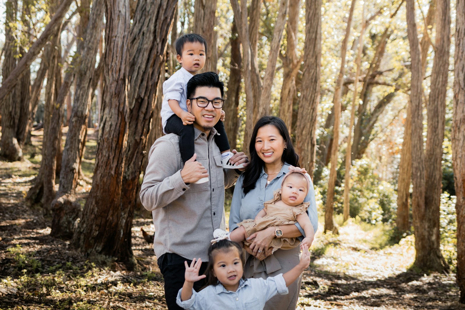 a family posing for a picture in the woods