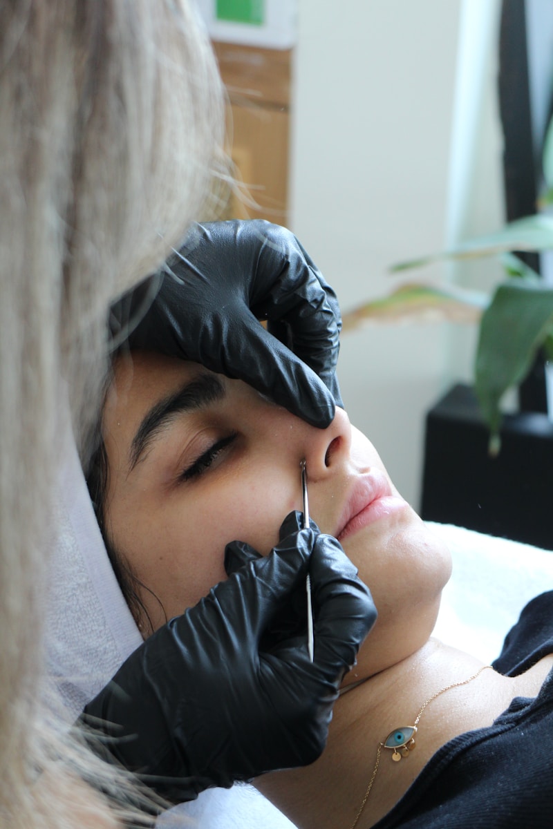 A woman getting her nose examined by a doctor