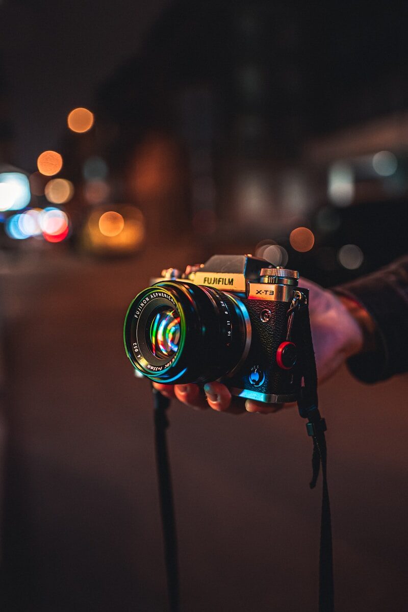 person holding black and silver nikon dslr camera